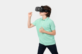 Boy in virtual reality headset holding something