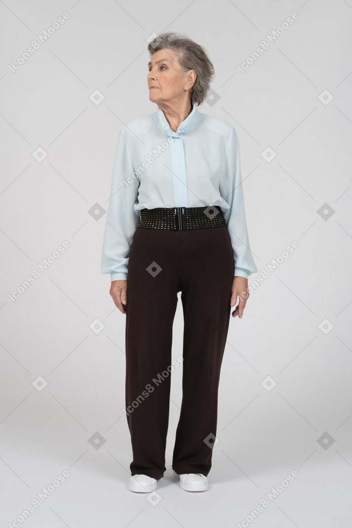 Old woman standing and looking aside