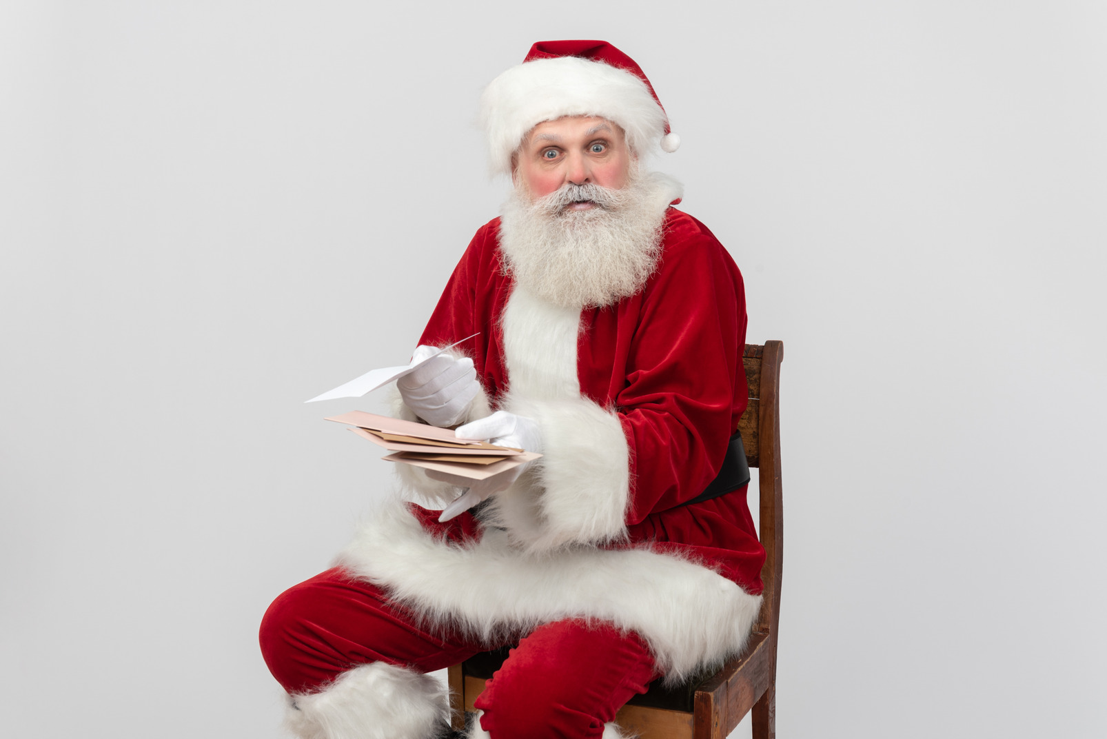 Santa claus sitting and reading letters