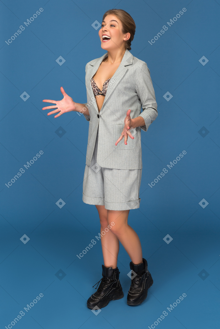 Excited young woman holding arms out