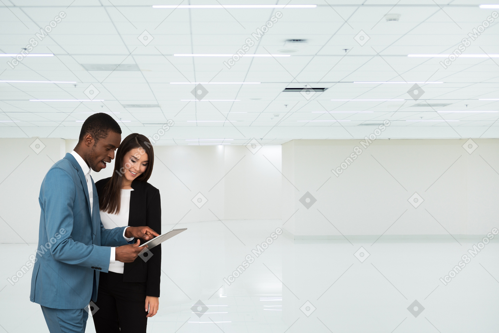 A man and a woman looking at a tablet