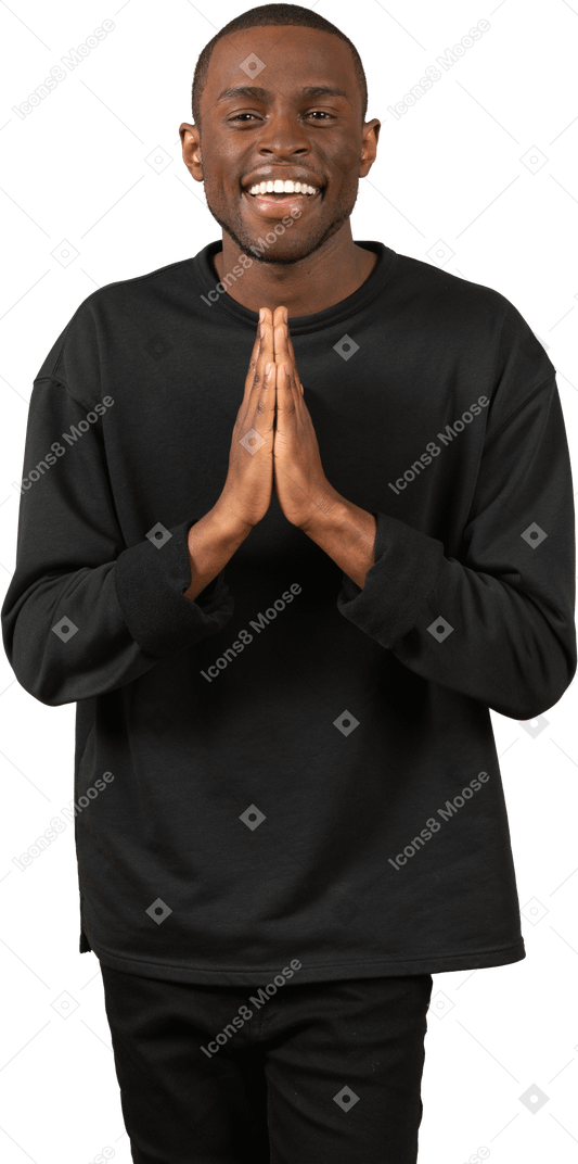 Grateful young man with folded hands