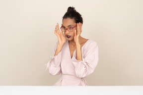 Young woman fixing her eyeglasses