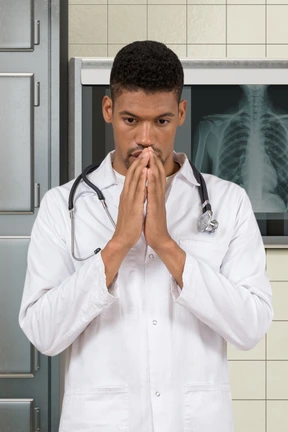 A doctor standing in front of a x - ray