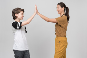 Pe teacher and pupil clapping hands together