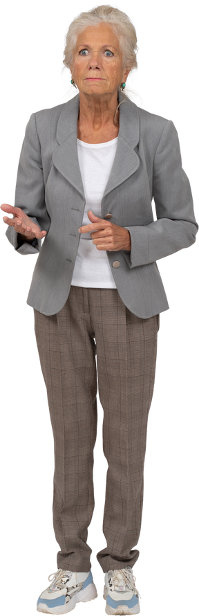 Front view of an angry old lady in suit pointing with hand