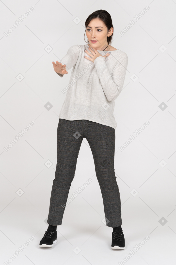 Scared woman making a stop hand gesture