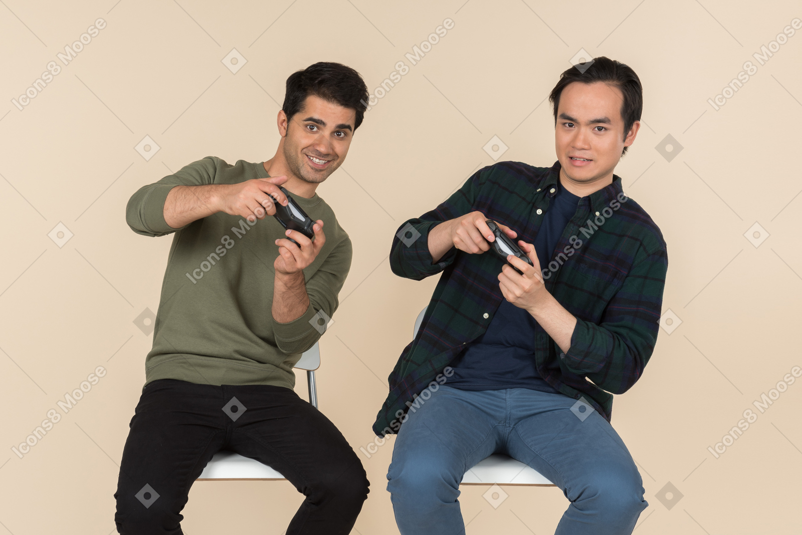 Interracial friends sitting in chairs and playing video games
