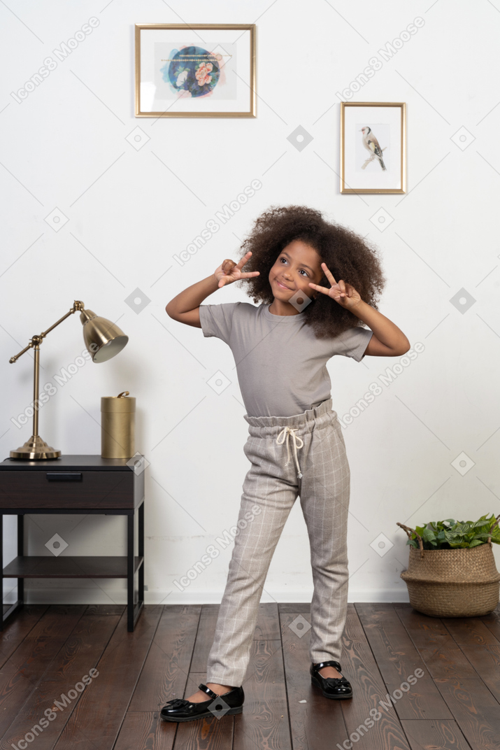 Good looking girl kid posing on the apartment background