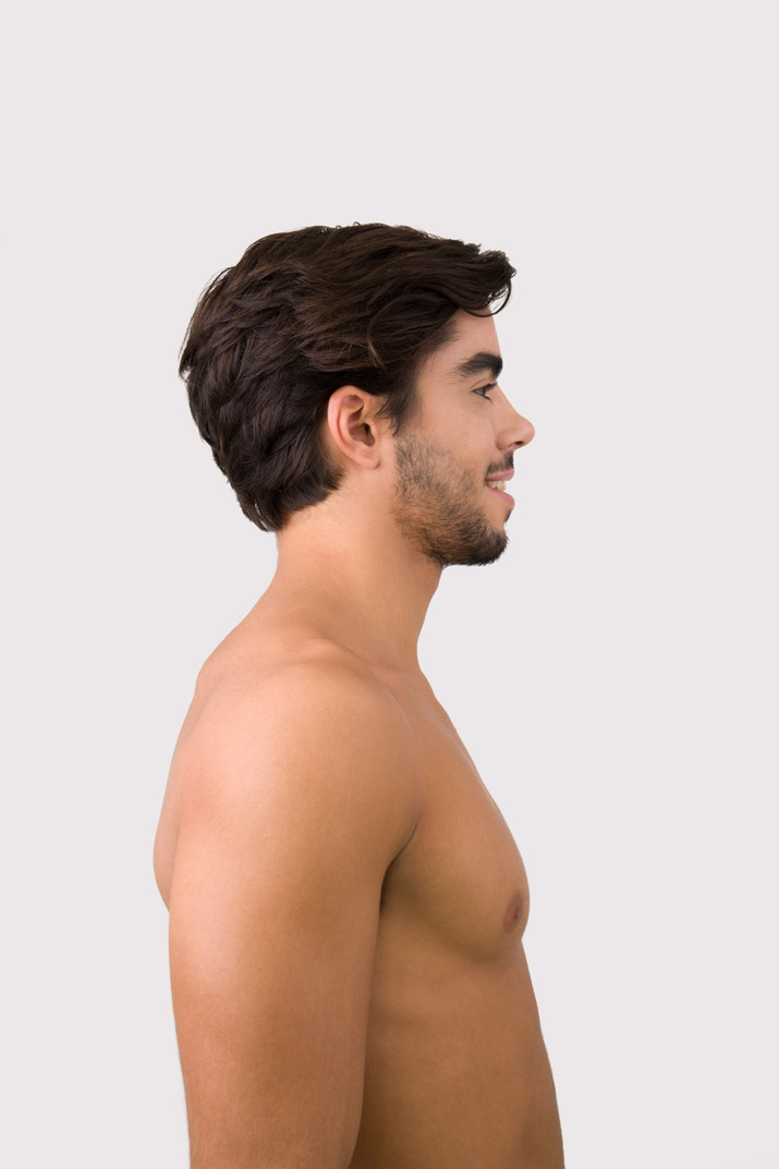 Young handsome man standing in profile