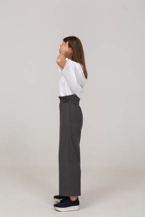 Side view of a young lady in office clothing shutting her eyes