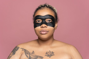 Woman using a black eye mask