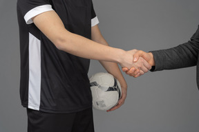 Football player shaking hands with someone
