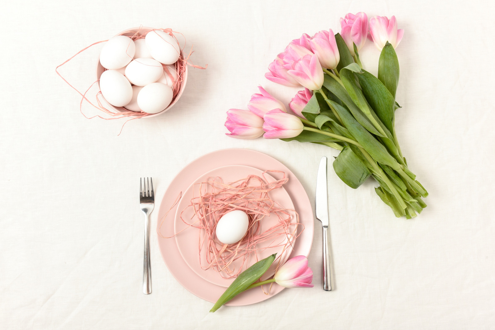Easter basket, tulip bouquet and a plate with an egg