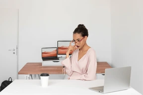 A woman sitting at a desk with a laptop