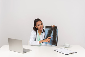 Beautiful female doctor with an x-ray photograph