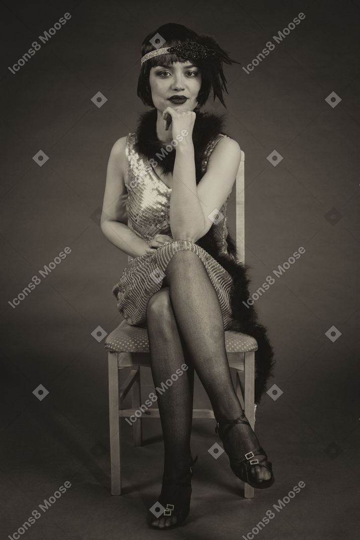 Black and white portrait of a vintage american flapper sitting leg to leg