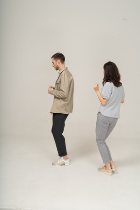 Shy young man and dancing young woman at a party