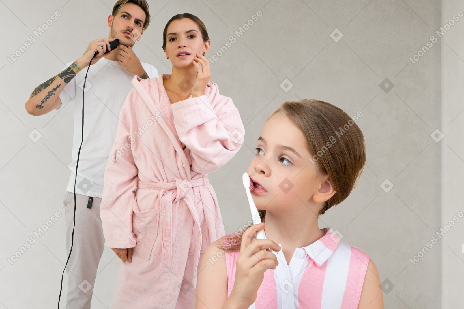 A young girl brushing her teeth, a woman touching her face and a man shaving