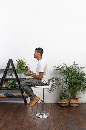 Good looking young man sitting on a chair