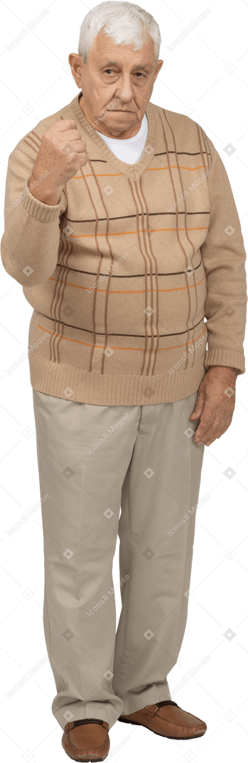 Front view of an old man in casual clothes showing fist