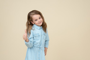 Cute little girl showing thumbs up