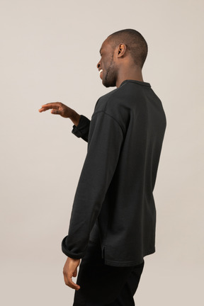 Rear view of black man waving hand