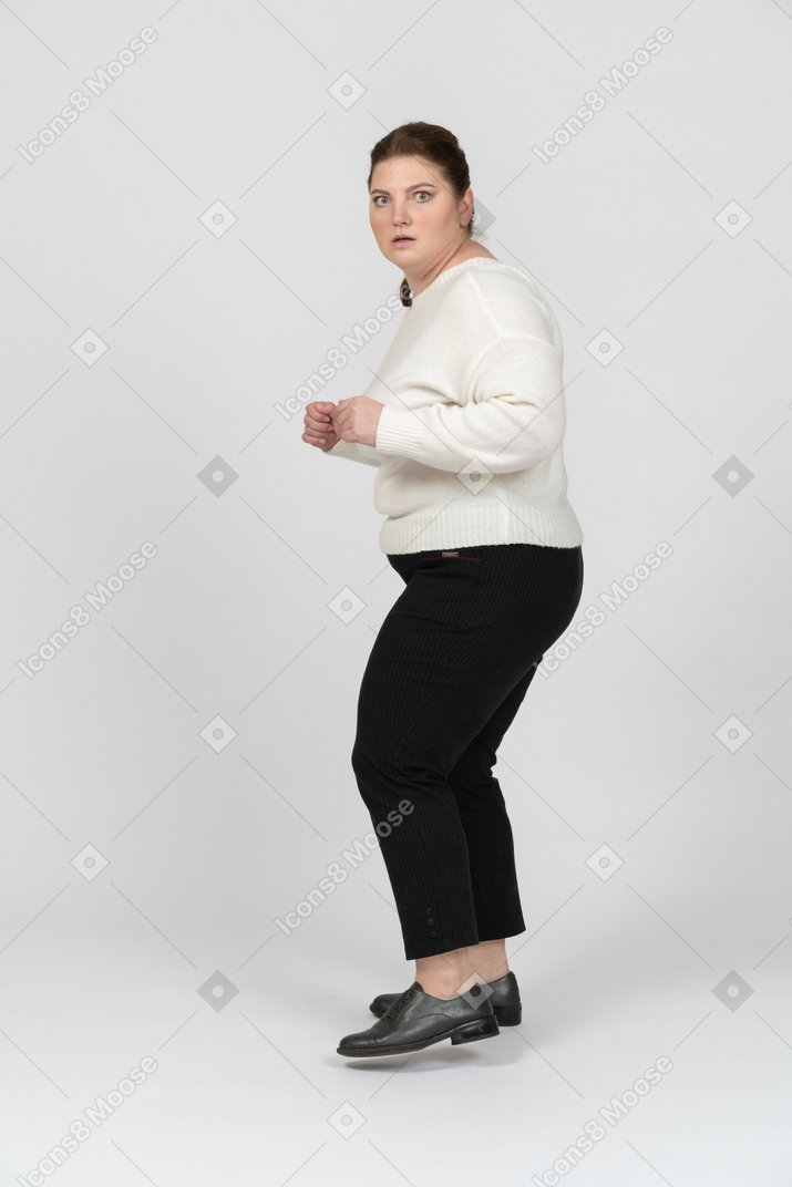 Plump woman in casual clothes is ready to fight