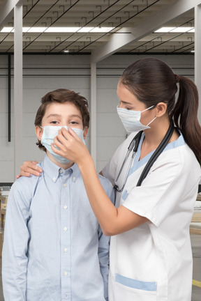 A woman and a boy wearing face masks