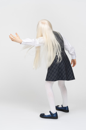 Back view of a schoolgirl leaning sideways