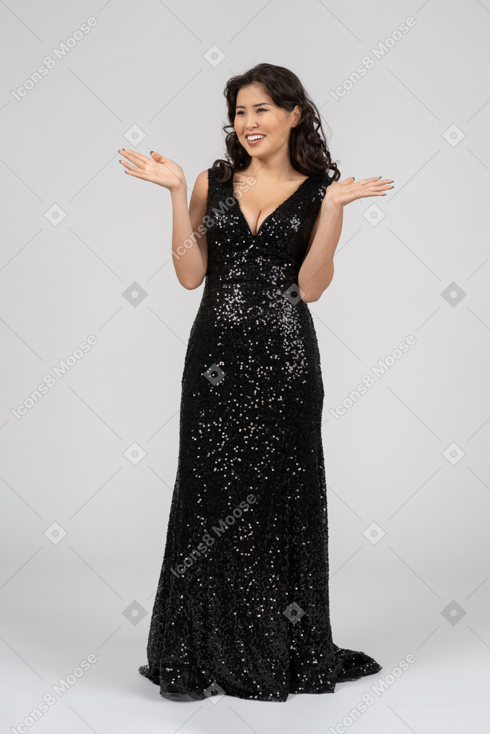Woman wearing black evening dress seems surprised