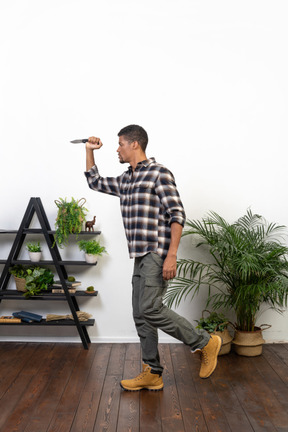 Side view of a tourist taking a step holding a knife