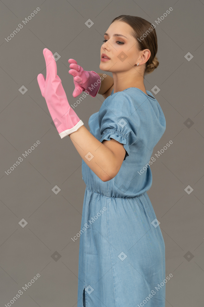 Portrait of a young woman gracefully moving her gloved hands