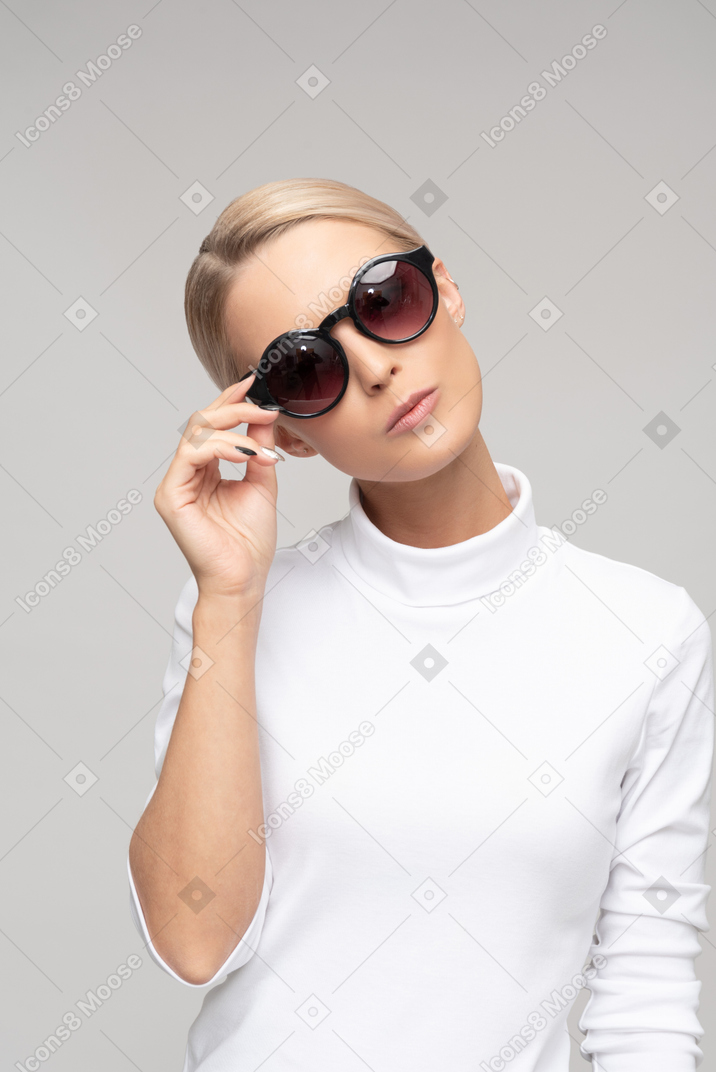 Attractive 'bossy' woman wearing sunglasses