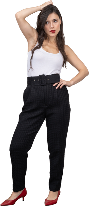 Front view of a confident young woman in office clothing posing and pouting