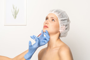 Woman looking nervous while getting botox injection