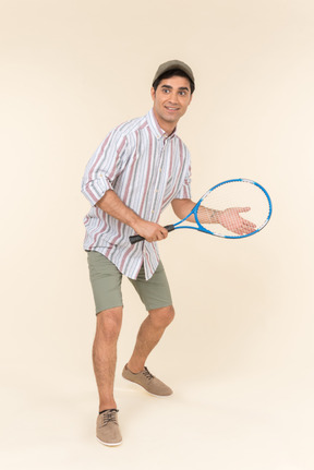 Young caucasian man holding tennis racket