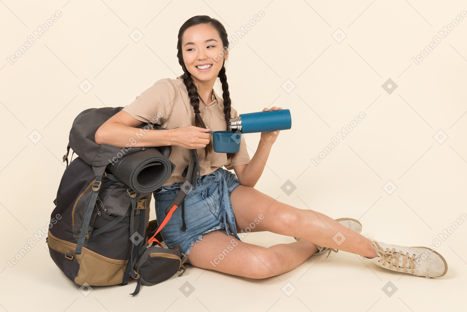 Young asian woman pouring liquid from thermos into thermos cup