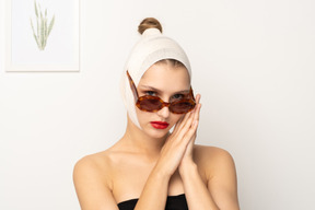 Woman in sunglasses folding her hands