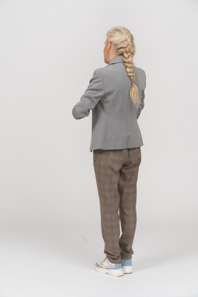 Rear view of an old lady in suit