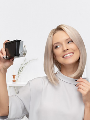A woman taking a picture of herself with a camera