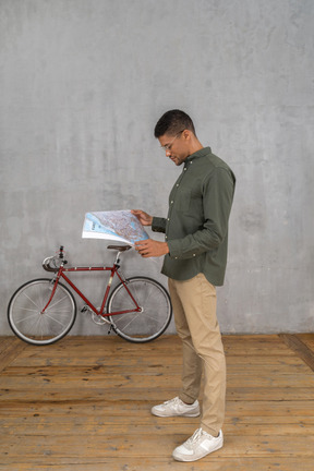 Side view of a man examining a map