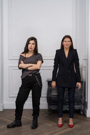 Two women looking annoyed