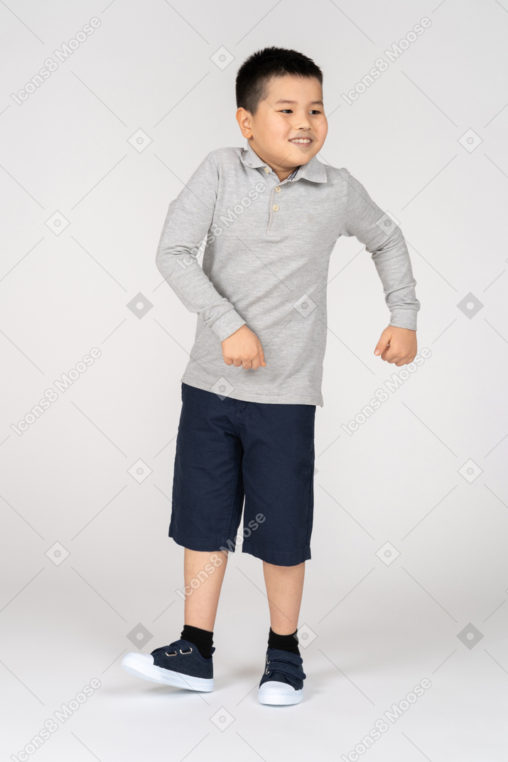 Cheerful little boy dancing