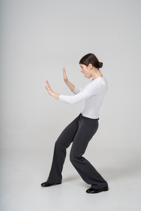 Side view of a woman showing stop gesture