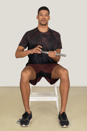 Young man in sports clothes lifting weights