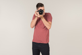 Young guy taking photos with a camera