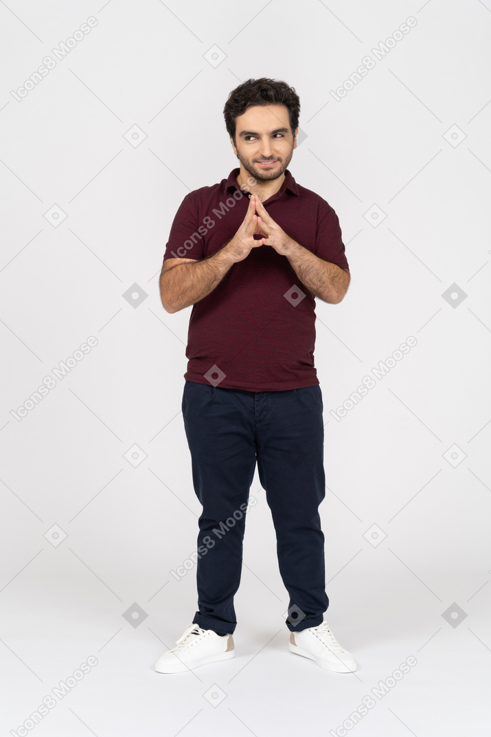 Man smiling slyly with folded hands