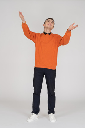 Young man in orange sweatshirt standing