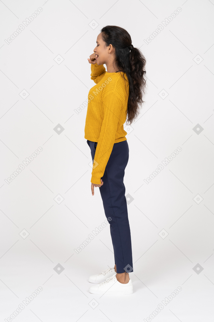 Side view of a girl in casual clothes biting finger